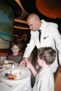 Photo of Maitre d' showing the kids a magic trick goes here.