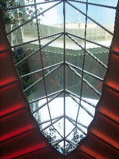 Photo looking upward from Royal Promenade through glass to Central Park goes here.