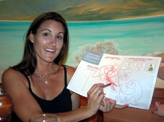 Photo of guest with the kids activity book provided to families in the dining room goes here. 