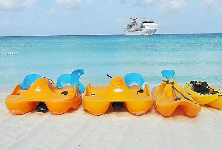 Photo of kayaks awaiting rental at Half Moon Cay; Carnival Splendor is in the background.*