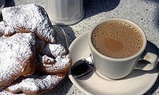 Photo of cafe du lait and beignets goes here.