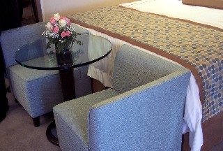 Photo of two-sided chairs and small table in the Penthouse suite goes here.