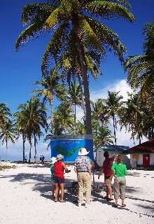 Photo of hikers beginning their trek around Half Moon Cay goes here.
