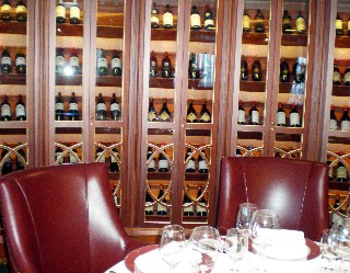 Photo of Polo Grill wine display and seating area goes here.