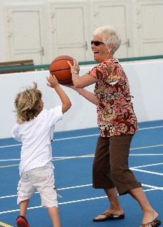 Photo of grandma playing with grandson on the Sports Court goes here.