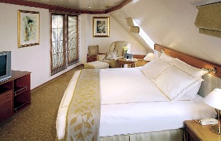 Phot of bedroom area of a Seven Seas Navigator Master Suite goes here.