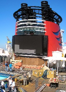 Photo of Disney ship in its drydock, with screen being added.