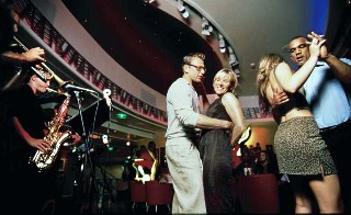 Photo of guests dancing on Royal Caribbean goes here.