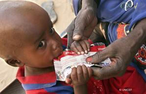 Photo of child eating UNICEF food packet goes here.*