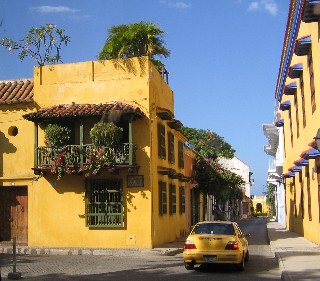 Photo of cab navigating a narrow street goes here.