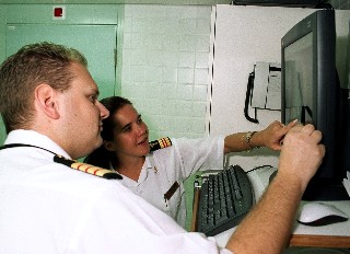 Photo of doctor and nurse reviewing test results on a computer goes here.