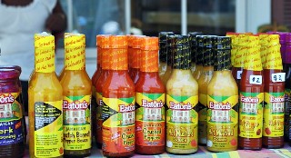 Photo of hot sauces sold at Falmouth, Jamaica, goes here.