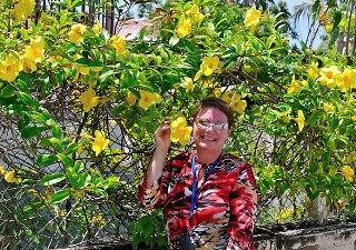 Photo of Lizz Dinnigan with flora of Falmouth, Jamaica goes here.