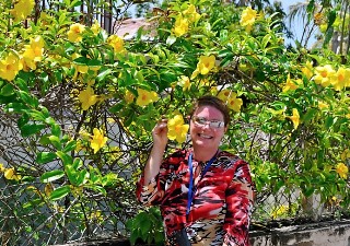 Photo of Lizz Dinnigan with flora of Falmouth, Jamaica goes here.
