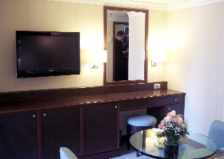 Photo of area across from the bed in the Penthouse Suite goes here.
