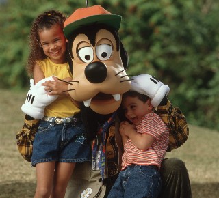 Photo of Pluto with two children at Disney World goes here.