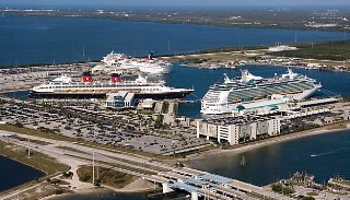 Photo of ships in port and the nearby roadway leading to the port goes here.