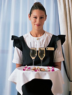 Photo of staff member with champagne for guests goes here.